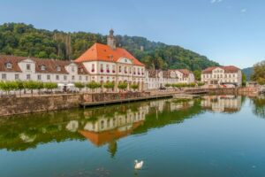 Scenic view of historic buildings reflected on the Weser river in Bad Karlshafen, Germany.