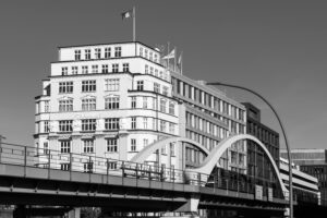 Black and white capture of Stella Haus and arch bridge in Hamburg, showcasing architectural elegance.